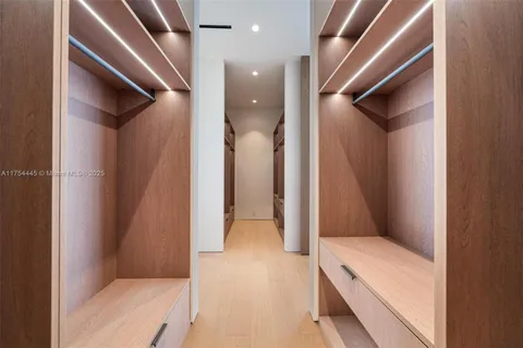 a bathroom with a sink a mirror and a potted plant