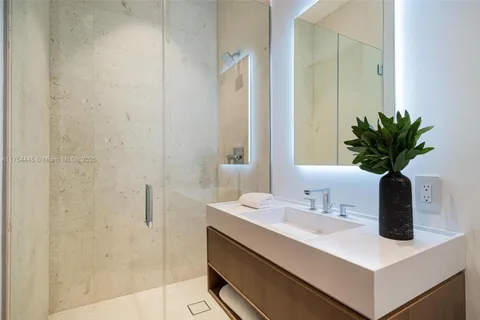 a bathroom with a sink a mirror and a shower