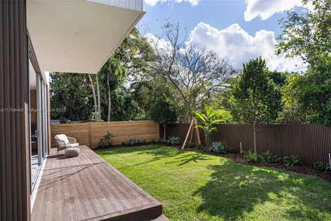 a view of a house with a yard and a garden