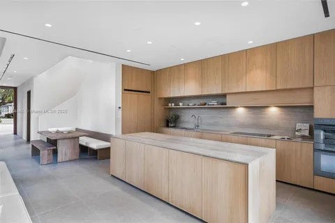 a kitchen with a sink and wooden cabinets