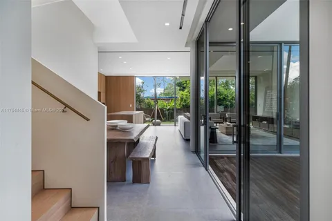 a bedroom with furniture a large window and a balcony