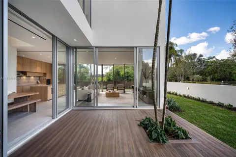 a view of a porch with wooden floor and outdoor seating