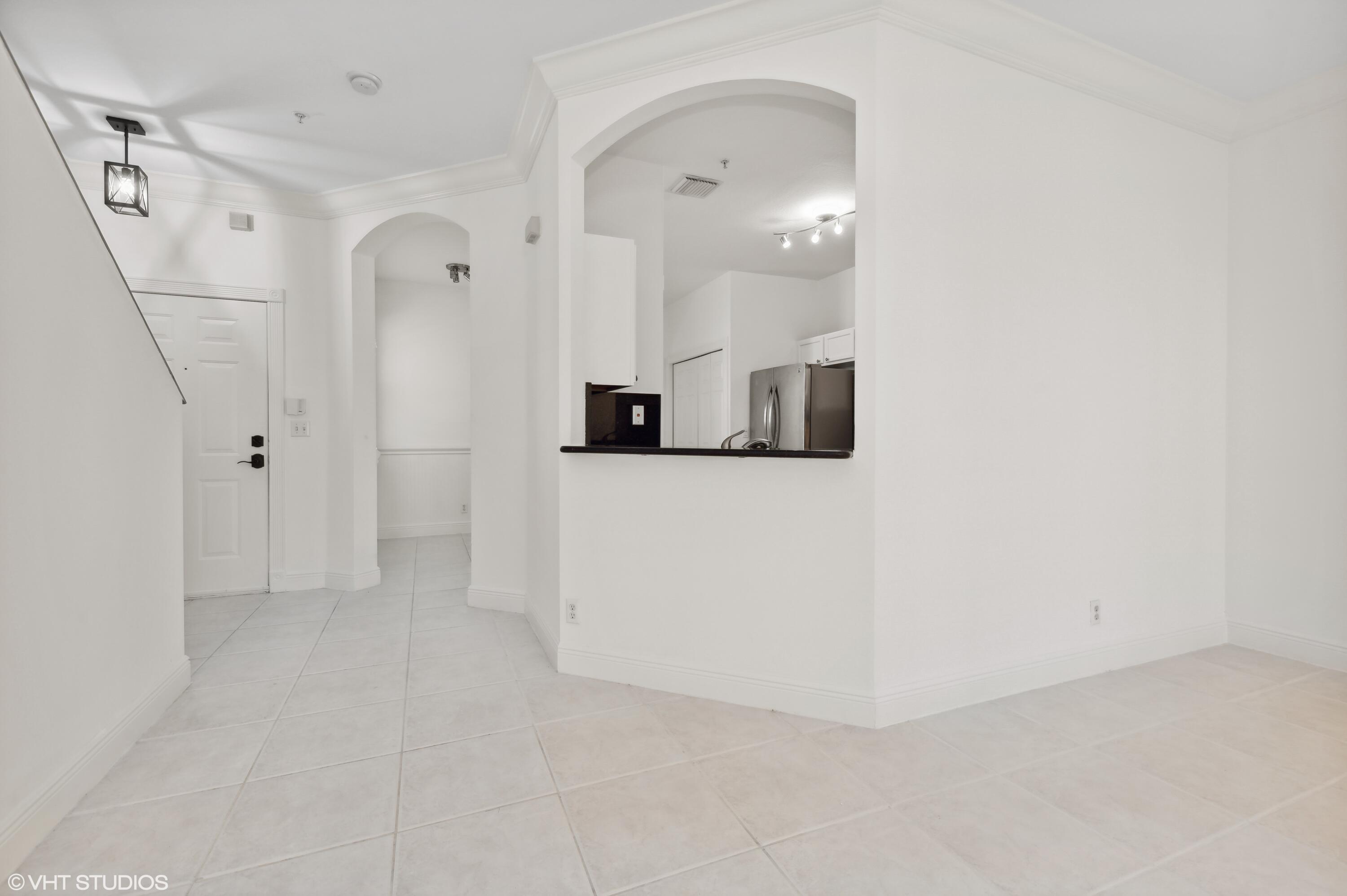 103 Lighthouse Circle, Unit D Tequesta, FL 33469 - Photo 15 of 36 an empty room with a mirror and a sink