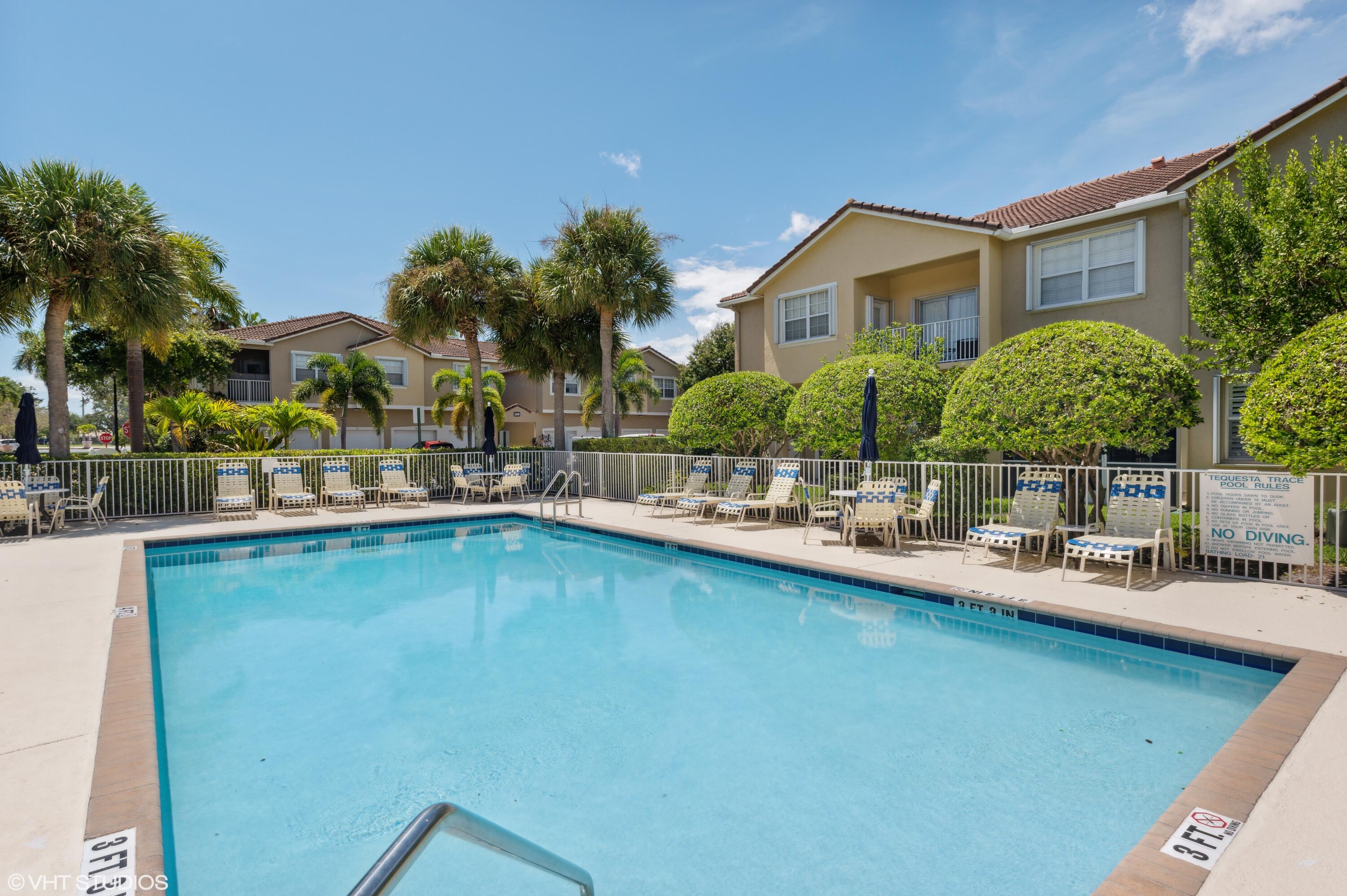 103 Lighthouse Circle, Unit D Tequesta, FL 33469 - Photo 32 of 36 a view of a house with pool and chairs