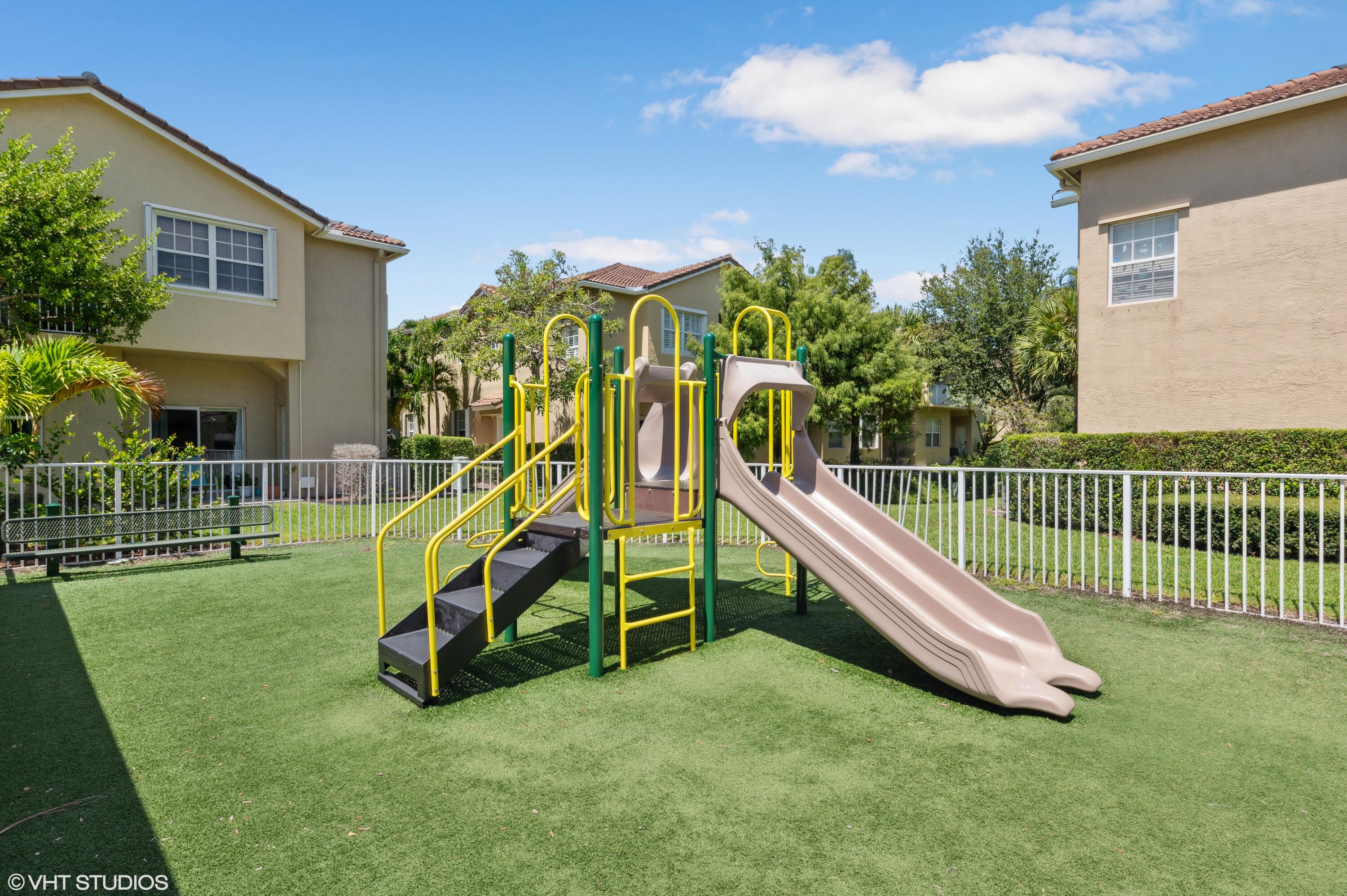 103 Lighthouse Circle, Unit D Tequesta, FL 33469 - Photo 33 of 36 a view of a house with a backyard
