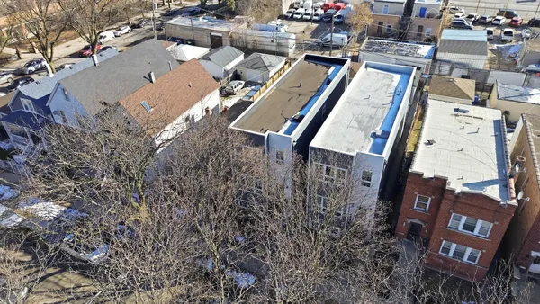 an aerial view of a residential apartment building with a yard