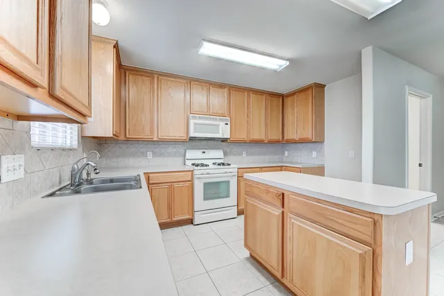 a kitchen with a sink stove and cabinets