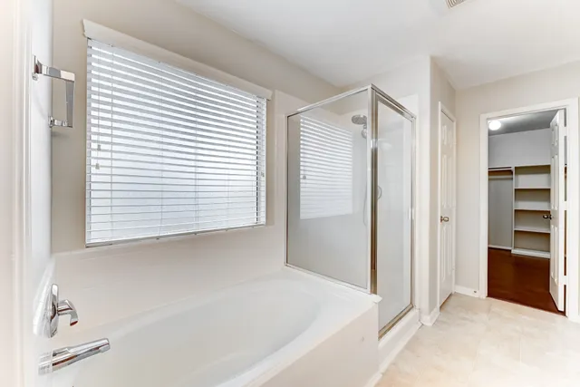 a bathroom with a bathtub and a shower