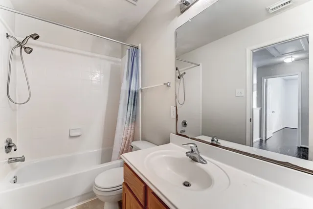 a bathroom with a sink toilet tub and shower