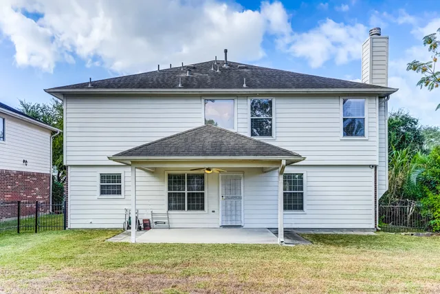 a front view of a house with a garden and yard