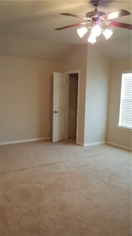 a view of an empty room with windows