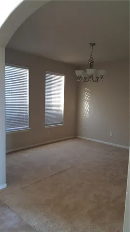 an empty room with a empty space and windows