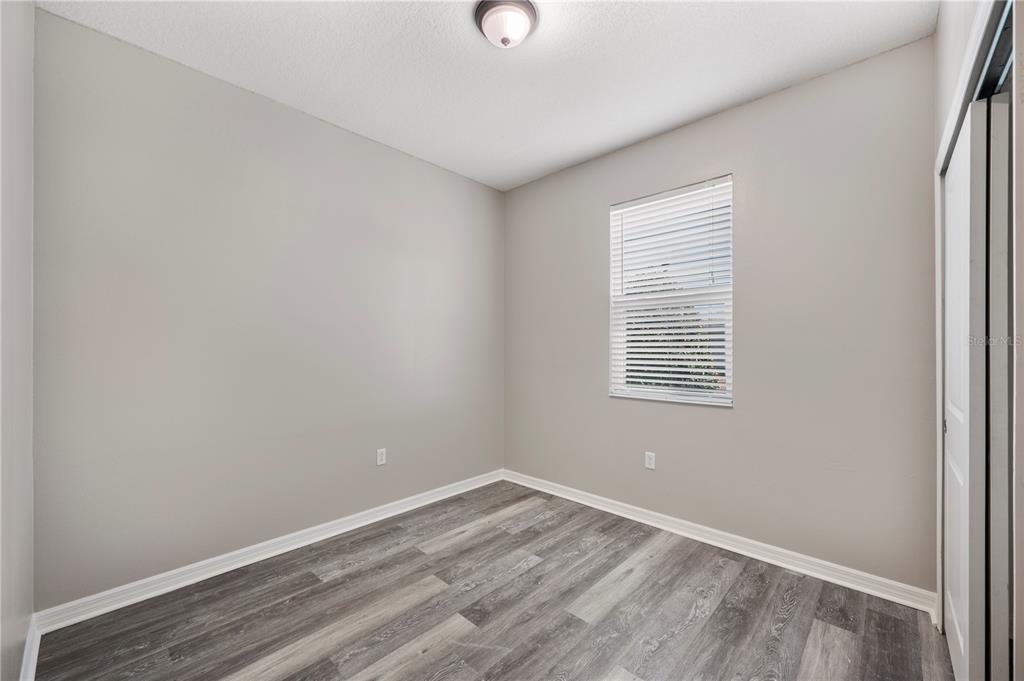 4303 Moon Shadow Loop Mulberry, FL 33860 - Photo 19 of 30 wooden floor in an empty room with a window