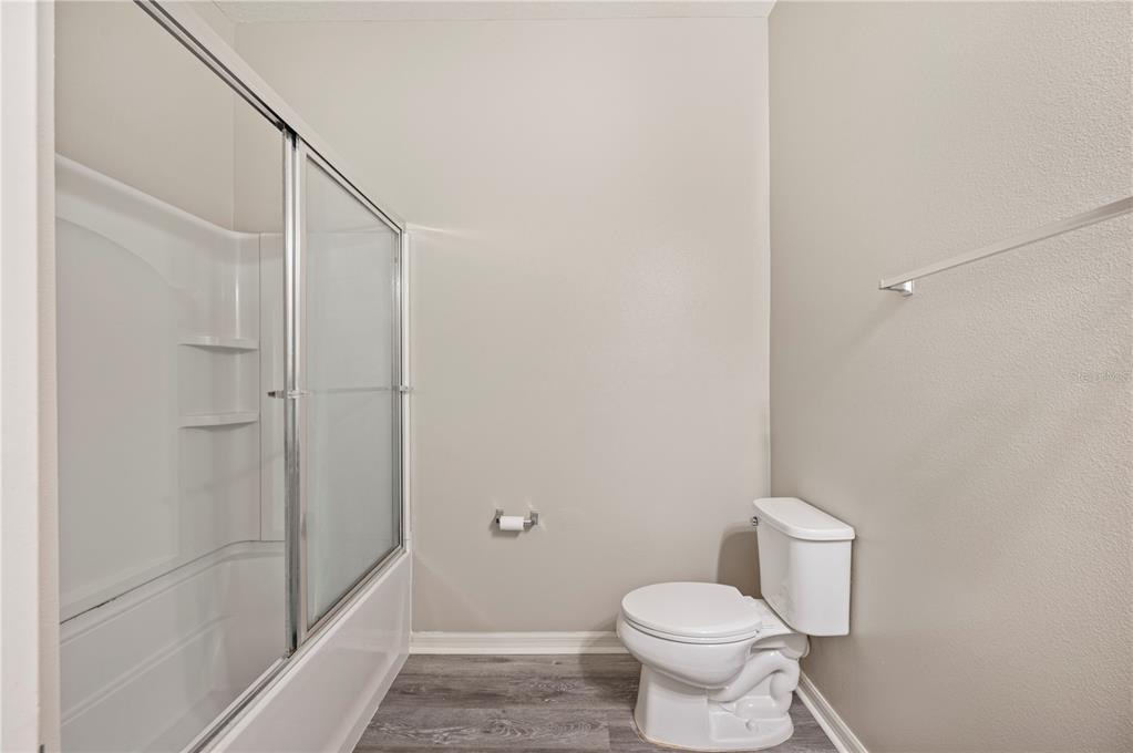 4303 Moon Shadow Loop Mulberry, FL 33860 - Photo 21 of 30 a white toilet sitting next to a shower