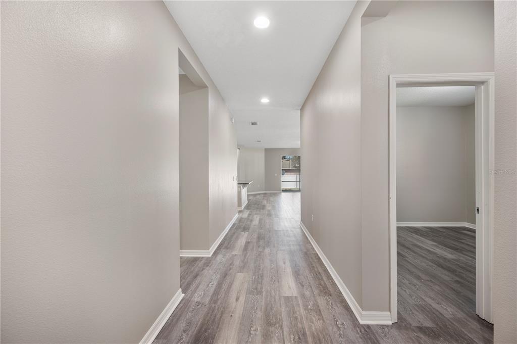 4303 Moon Shadow Loop Mulberry, FL 33860 - Photo 24 of 30 a view of a hallway with wooden floor