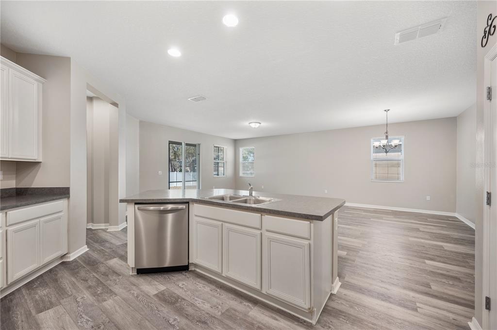 4303 Moon Shadow Loop Mulberry, FL 33860 - Photo 4 of 30 a kitchen with granite countertop a sink and cabinets
