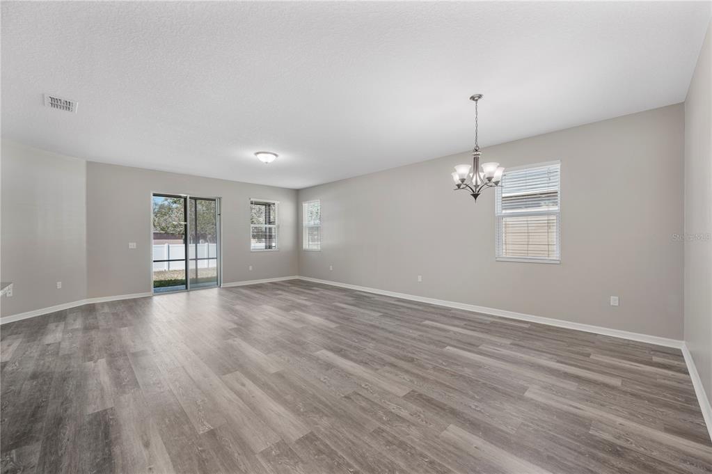 4303 Moon Shadow Loop Mulberry, FL 33860 - Photo 7 of 30 a view of an empty room with window and wooden floor