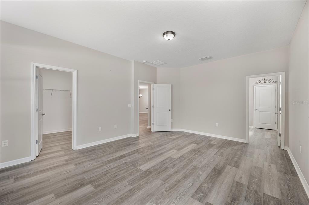 4303 Moon Shadow Loop Mulberry, FL 33860 - Photo 9 of 30 a view of an empty room with wooden floor