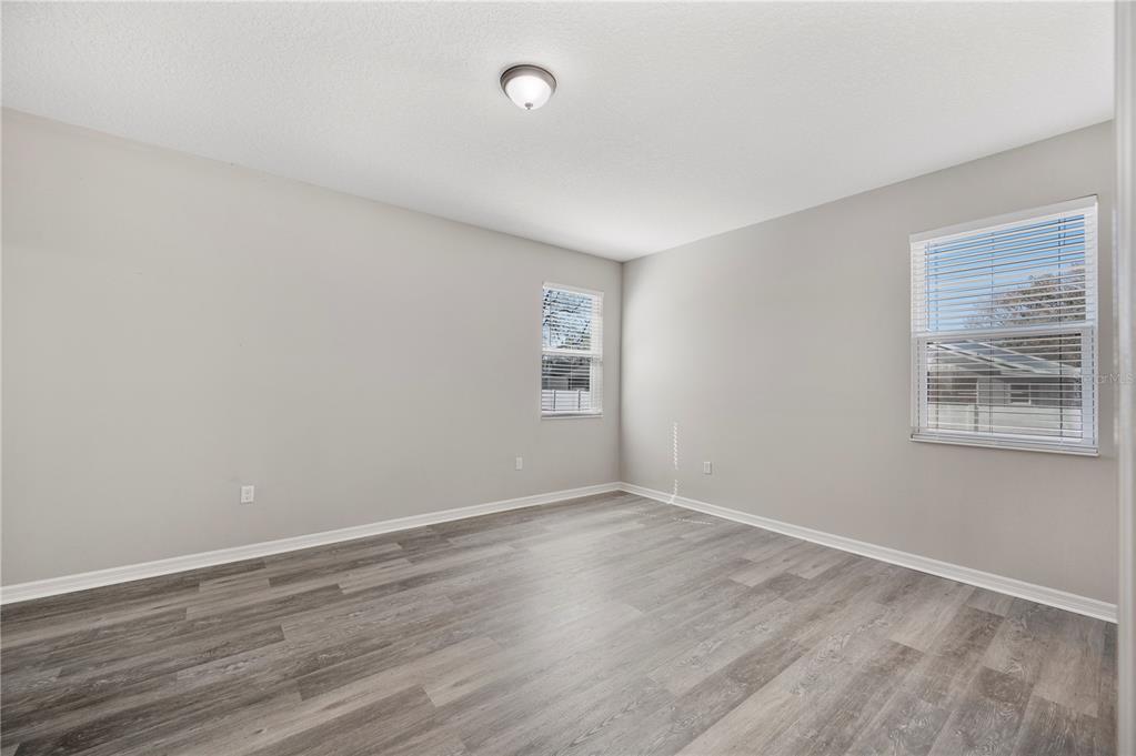 4303 Moon Shadow Loop Mulberry, FL 33860 - Photo 10 of 30 a view of an empty room with wooden floor and a window