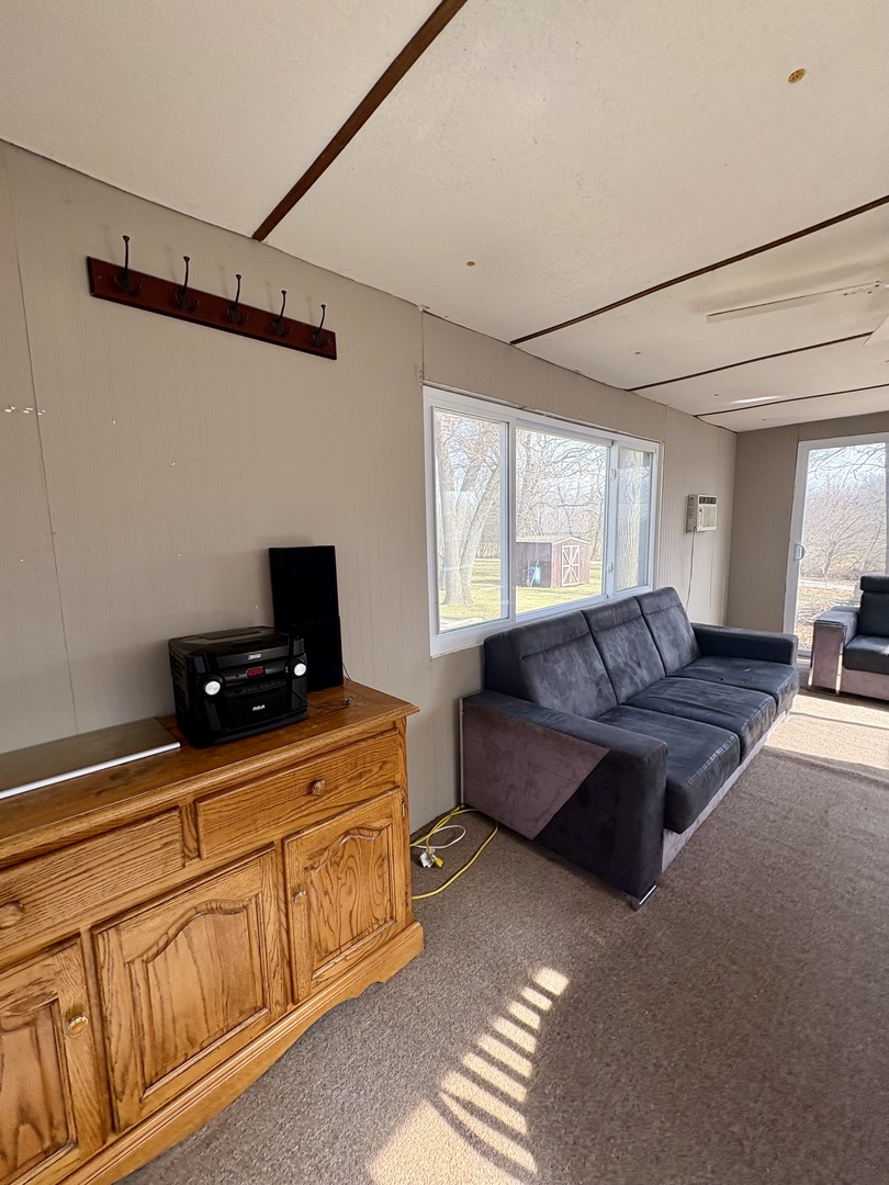 5-498 Woodhaven Sublette, IL 61367 - Photo 21 of 22 a living room with furniture and a flat screen tv