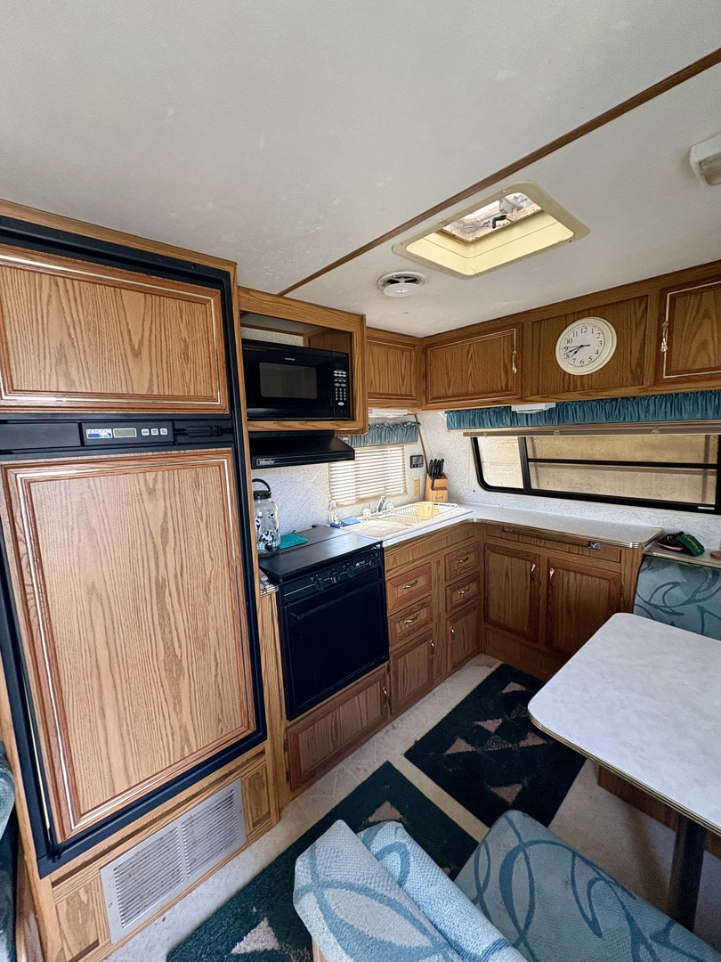 5-498 Woodhaven Sublette, IL 61367 - Photo 10 of 22 a kitchen with a refrigerator and a stove top oven