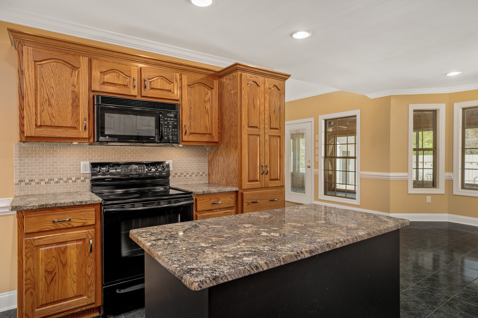 434 Alexander Road Estill Springs, TN 37330 - Photo 14 of 64 a kitchen with stainless steel appliances granite countertop a stove sink and microwave