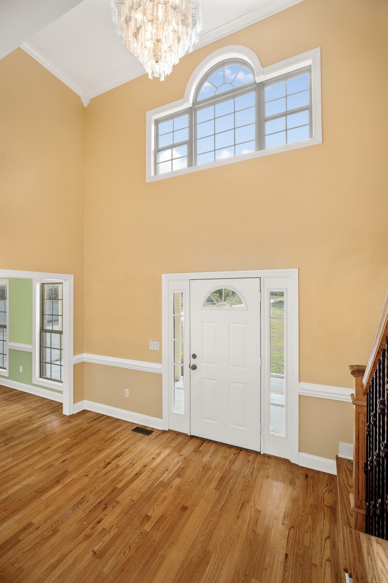 434 Alexander Road Estill Springs, TN 37330 - Photo 7 of 64 a view of an empty room with wooden floor and a window