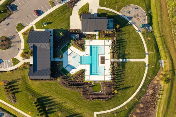 a view of swimming pool with outdoor seating and yard in back