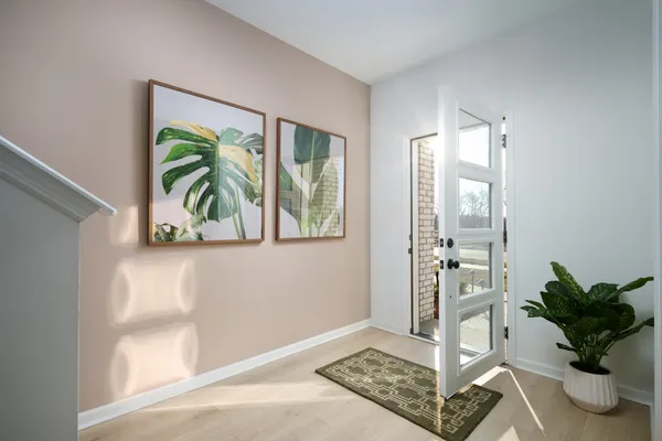 a kitchen with stainless steel appliances a stove a sink a microwave a refrigerator and white cabinets