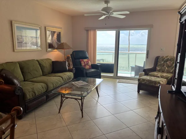 a living room with furniture and a floor to ceiling window