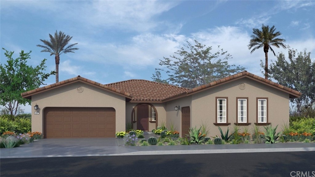 82066 Verdi Road Indio, CA 92203 - Photo 1 of 18 a front view of a house with a garden and plants