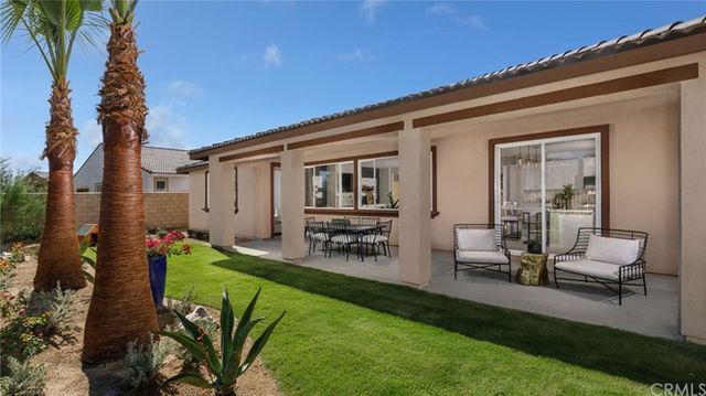 a view of backyard of the house with outdoor seating