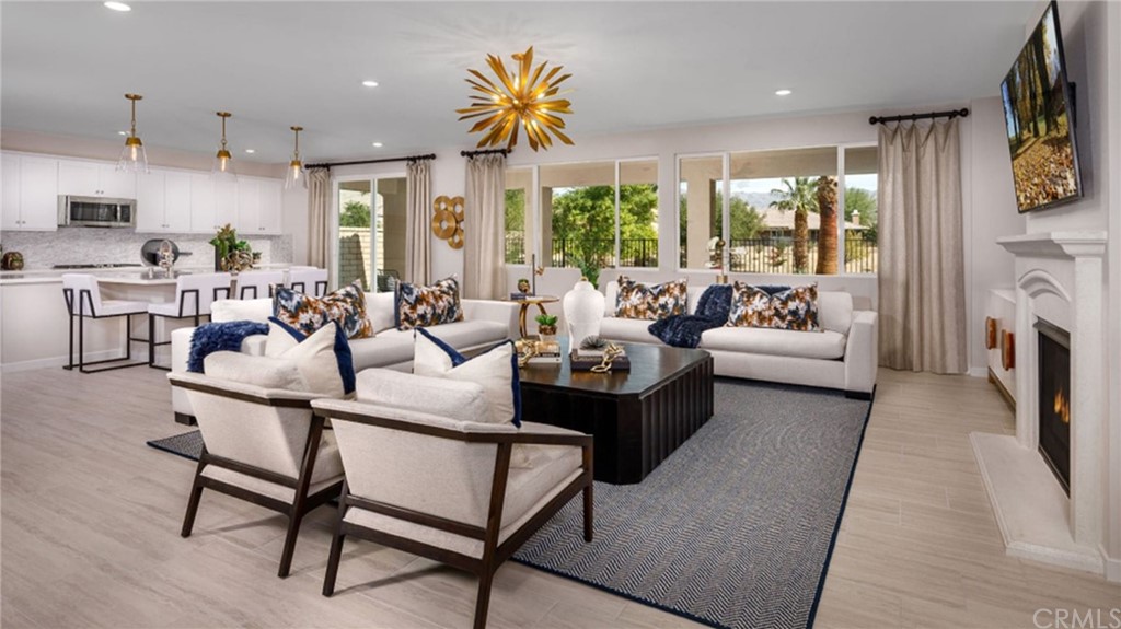82066 Verdi Road Indio, CA 92203 - Photo 2 of 18 a living room with fireplace furniture and a large window