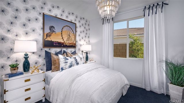 a bedroom with bed and a chandelier