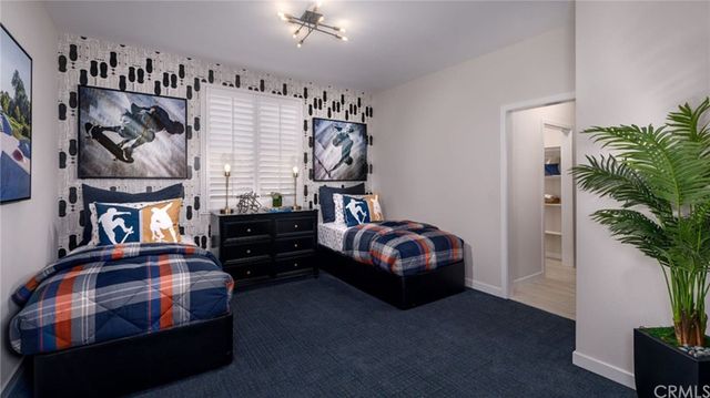 a bedroom with bed and a potted plant