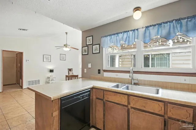 a kitchen with a stove a sink and a refrigerator