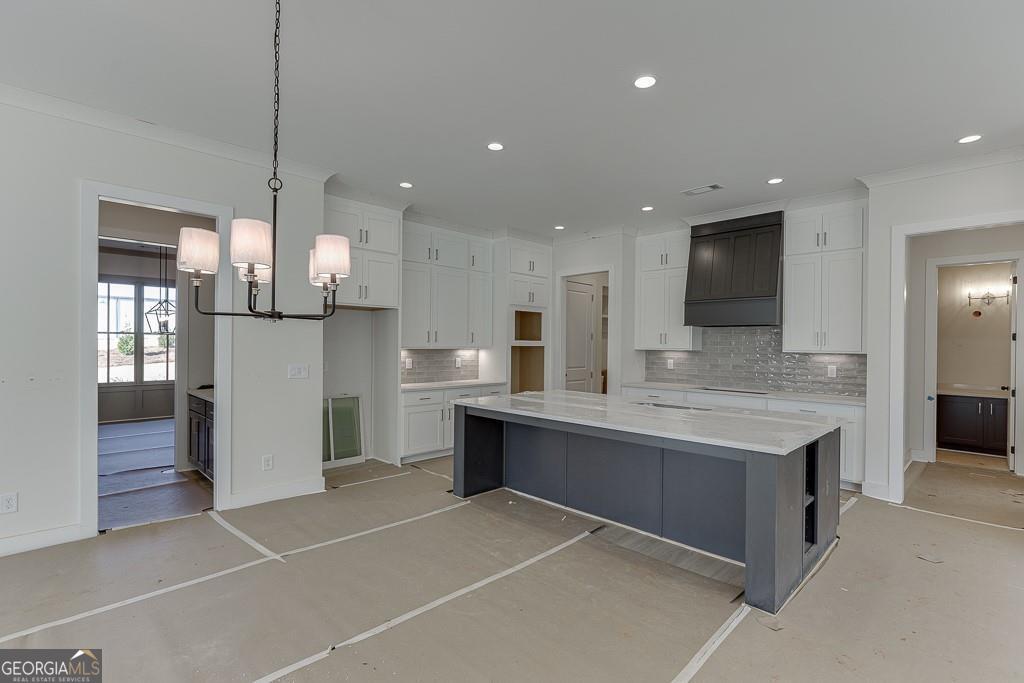 5470 Settingdown Road Cumming, GA 30028 - Photo 12 of 46 a large kitchen with kitchen island a sink stainless steel appliances and cabinets