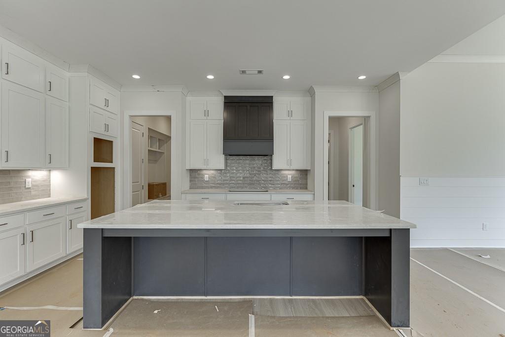 5470 Settingdown Road Cumming, GA 30028 - Photo 13 of 46 a view of a kitchen counter space a sink stainless steel appliances and cabinets