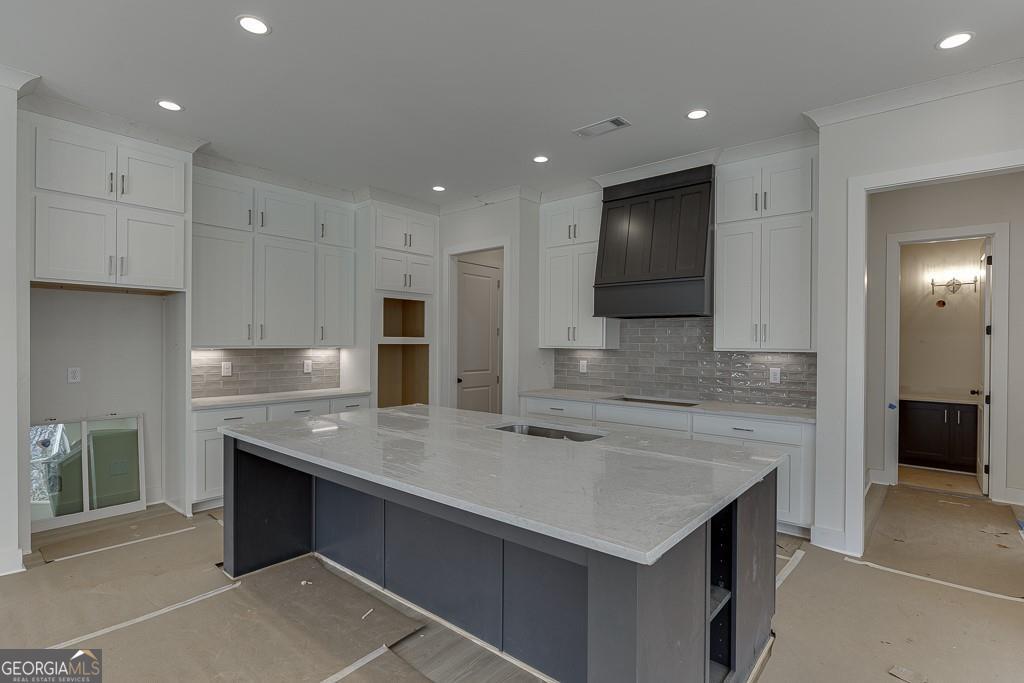 5470 Settingdown Road Cumming, GA 30028 - Photo 14 of 46 a large kitchen with stainless steel appliances granite countertop a sink and a stove