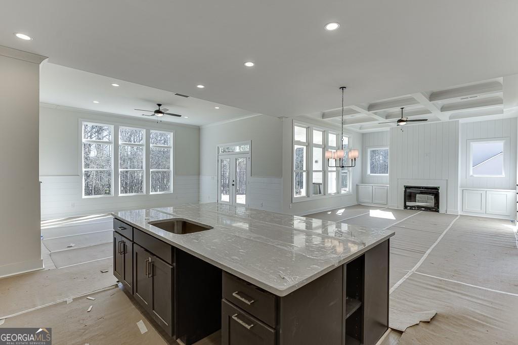 5470 Settingdown Road Cumming, GA 30028 - Photo 16 of 46 a kitchen with granite countertop a stove and a sink