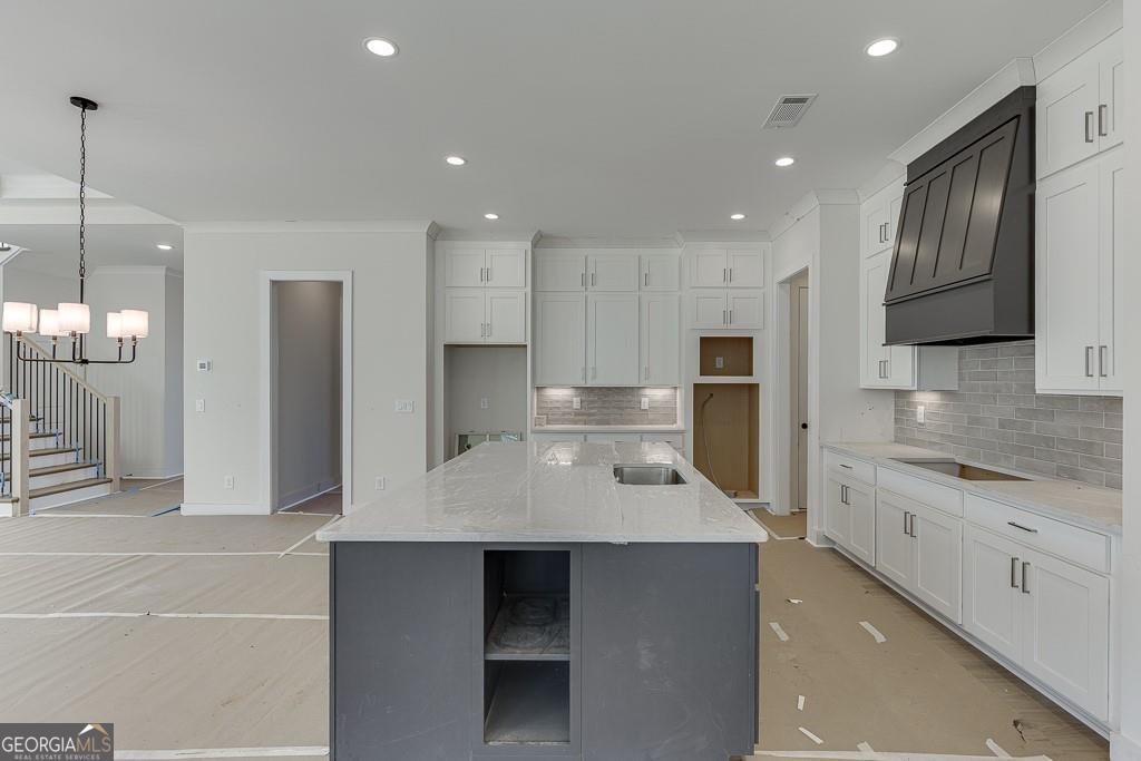 5470 Settingdown Road Cumming, GA 30028 - Photo 18 of 46 a large kitchen with granite countertop a large counter top stainless steel appliances and cabinets