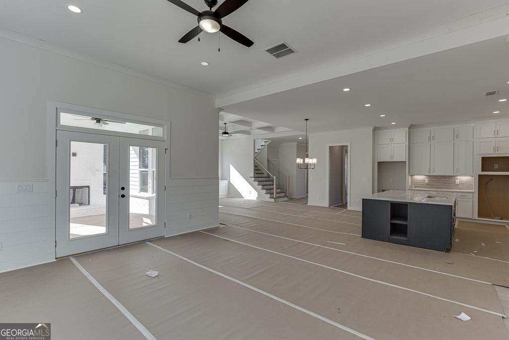 5470 Settingdown Road Cumming, GA 30028 - Photo 20 of 46 a room with stainless steel appliances kitchen island granite countertop a refrigerator and a sink