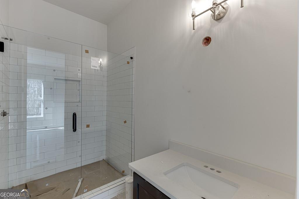 5470 Settingdown Road Cumming, GA 30028 - Photo 27 of 46 a bathroom with a sink and shower