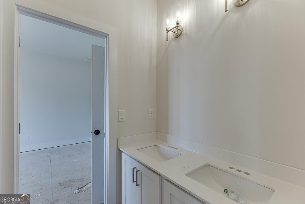 5470 Settingdown Road Cumming, GA 30028 - Photo 32 of 46 a bathroom with a sink and a mirror