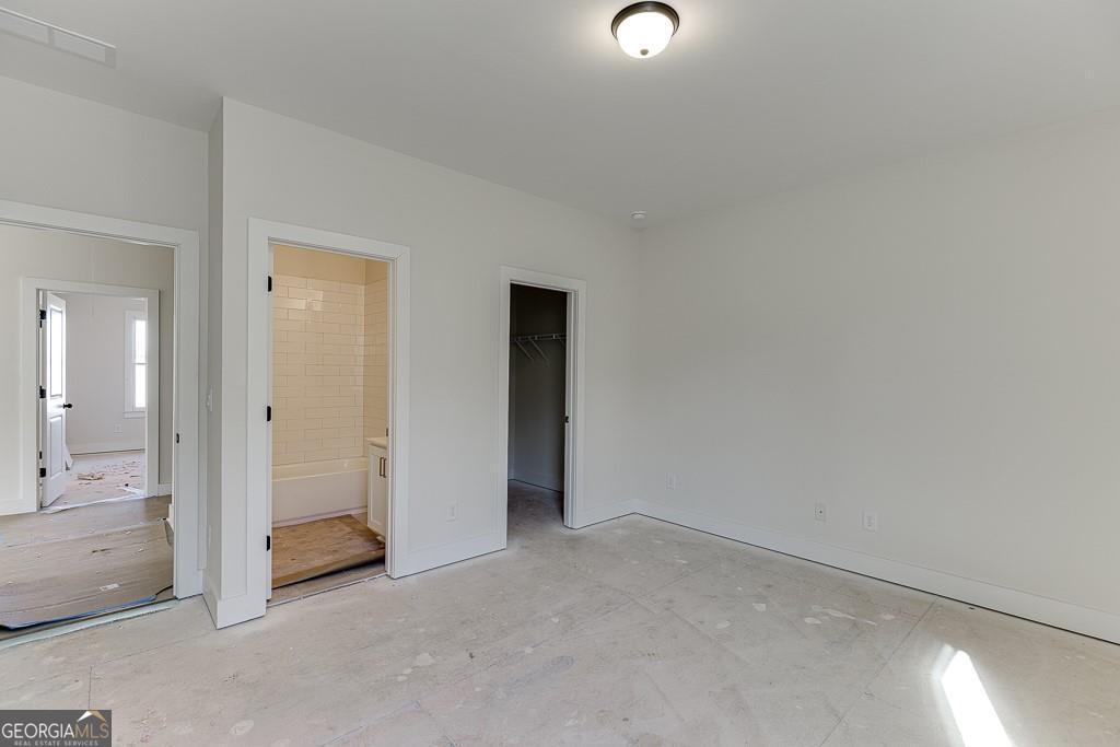 5470 Settingdown Road Cumming, GA 30028 - Photo 35 of 46 an empty room with a bathroom