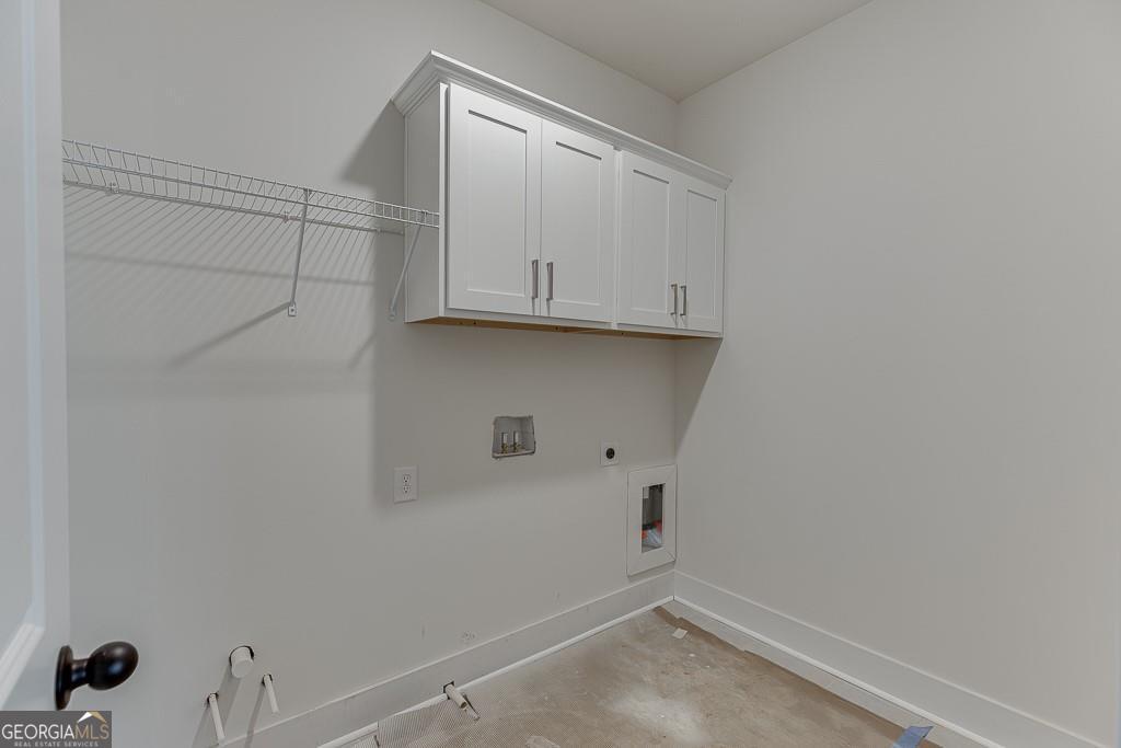 5470 Settingdown Road Cumming, GA 30028 - Photo 37 of 46 a view of storage and utility room with empty racks