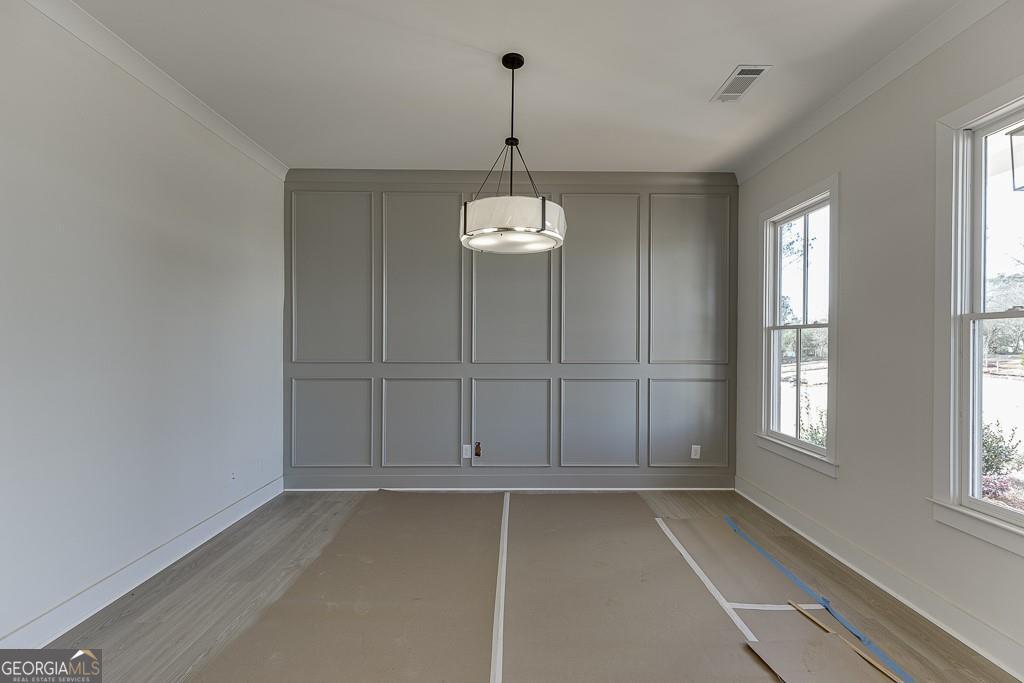 5470 Settingdown Road Cumming, GA 30028 - Photo 4 of 46 an empty room with windows and cabinet