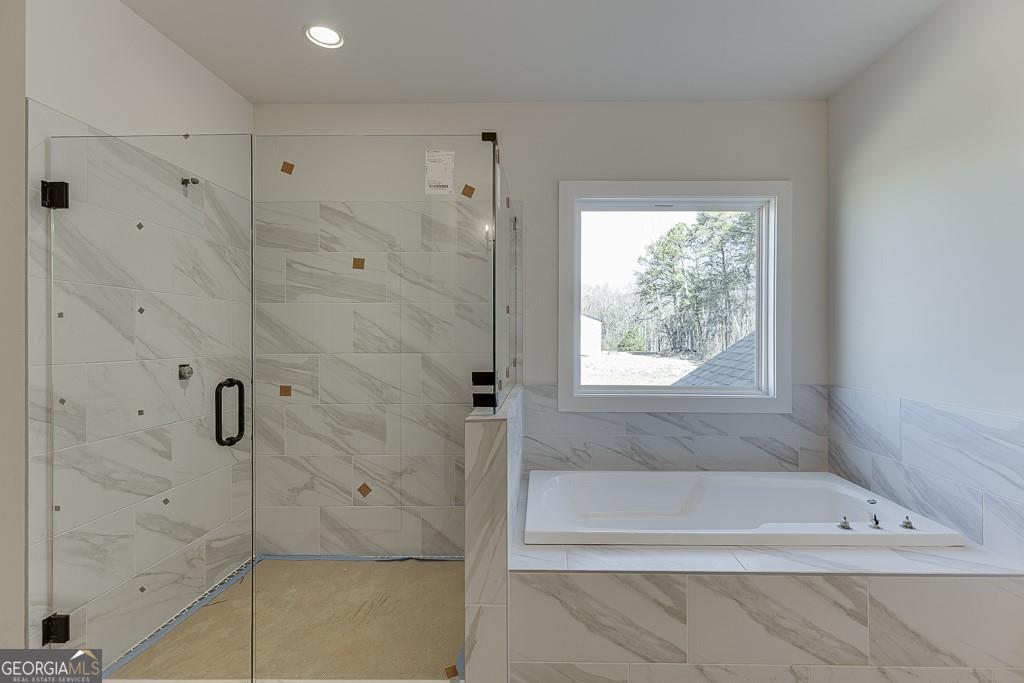 5470 Settingdown Road Cumming, GA 30028 - Photo 41 of 46 a bathroom with a bathtub and shower