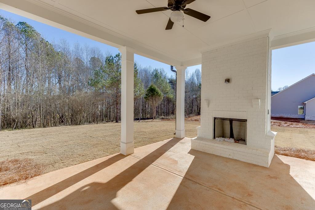 5470 Settingdown Road Cumming, GA 30028 - Photo 43 of 46 a view of a livingroom with a fireplace a ceiling fan and hardwood floor