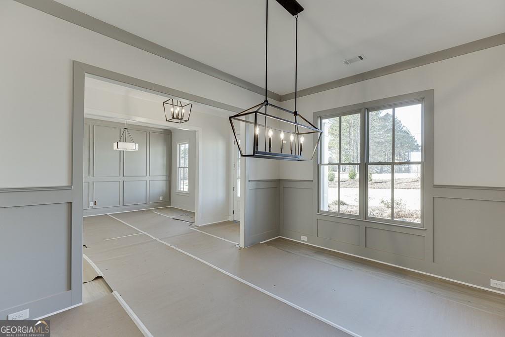 5470 Settingdown Road Cumming, GA 30028 - Photo 9 of 46 a view of empty room with wooden floor and chandelier